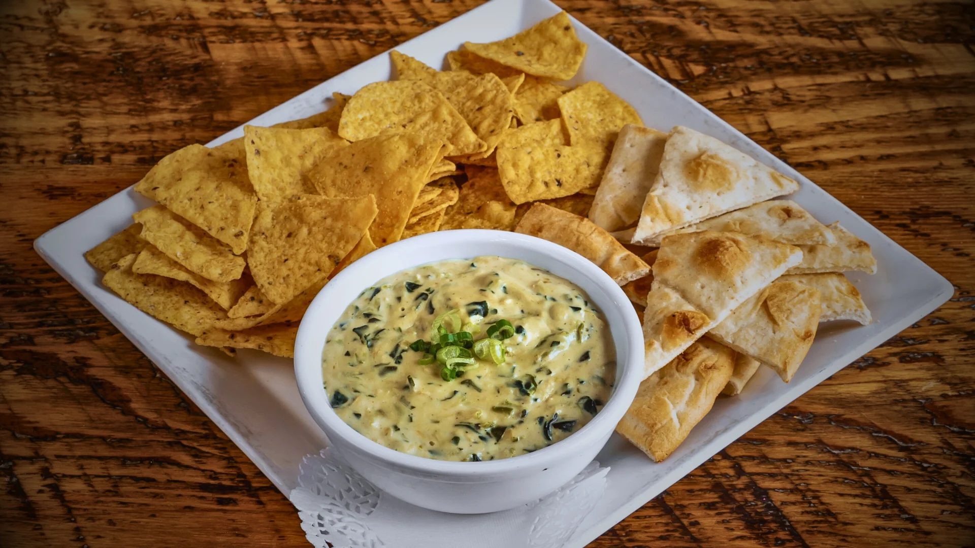 Three cheese spinach dip with naan bread and tortillas